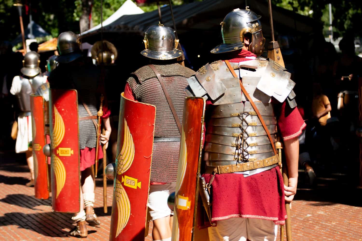 roman soldiers seen from behind with shields, roman army reenactment event