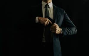 A man wearing suit with semi automatic pistol
