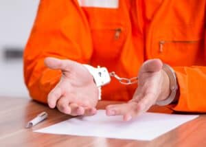 Young man writing letter in provisional detention