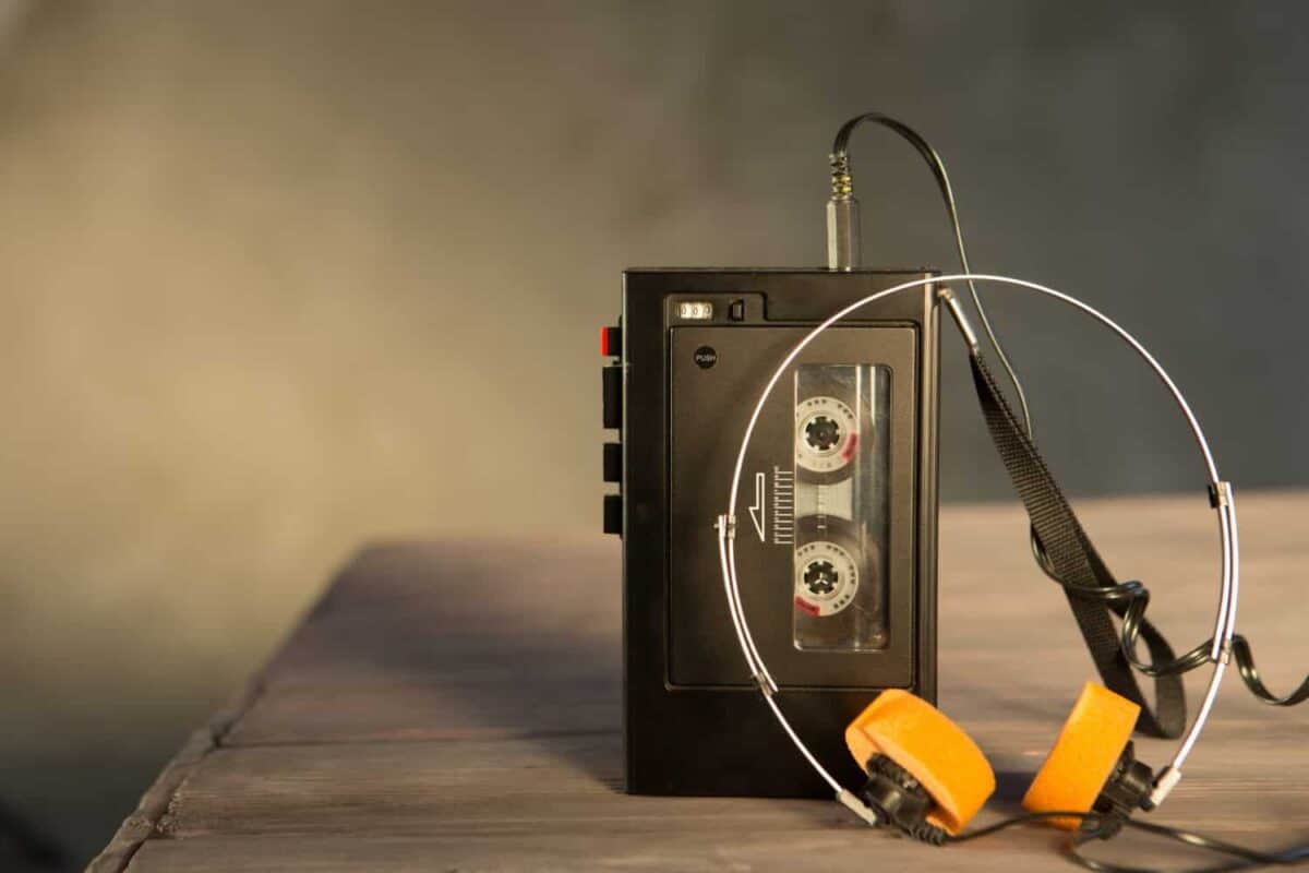 Old portable cassette player on a wooden background